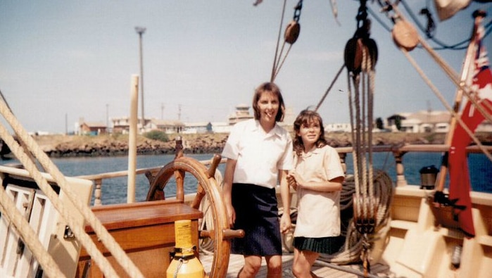 Two women in white tops on an old sailing ship in 1988