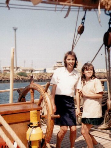 Two women in white tops on an old sailing ship in 1988
