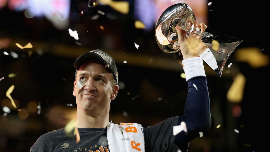 Denver quarterback Peyton Manning #18 holds the Vince Lombardi Trophy after winning Super Bowl 50.