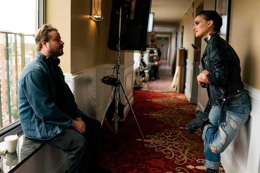 Colour photo of director Brady Corbet and Natalie Portman on the set of 2018 film Vox Lux.