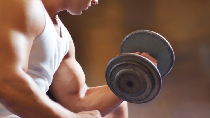 A young man with big biceps lifting a big weight