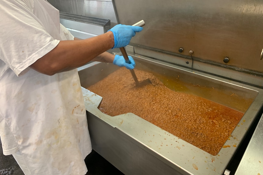 Prisoner stirring Bolognaise cooked in the West Kimberley Regional Prison kitchen. 