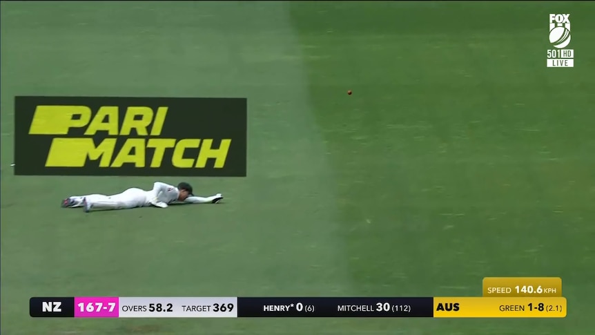 a person diving for a cricket ball while a logo for parimatch was featured