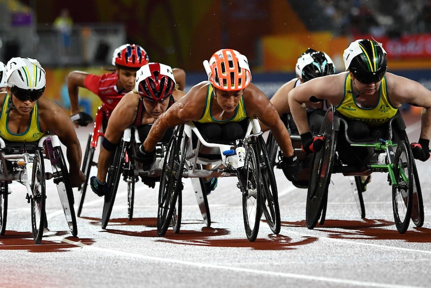 Three Australians are out in front of a wheelchair sprint race.