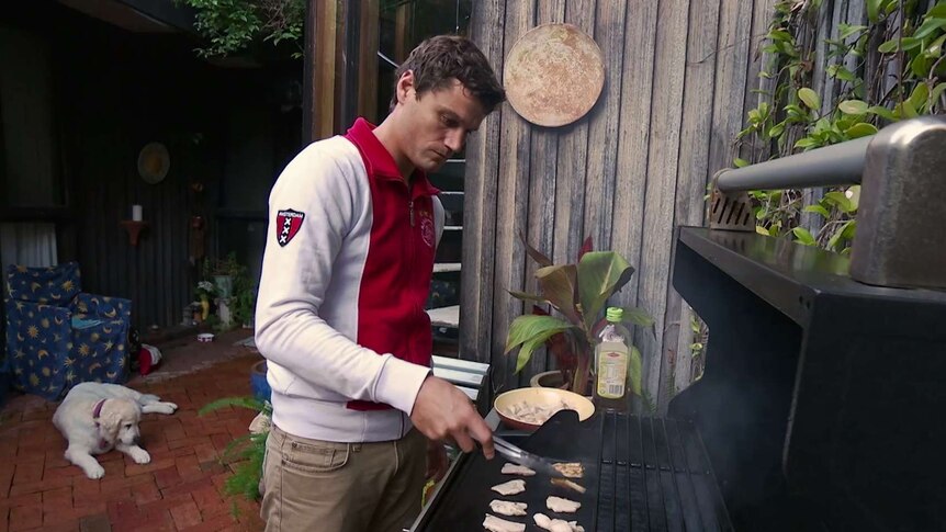 Paul Menke from Mallacoota is cooking abalone on his barbecue in Mallacoota