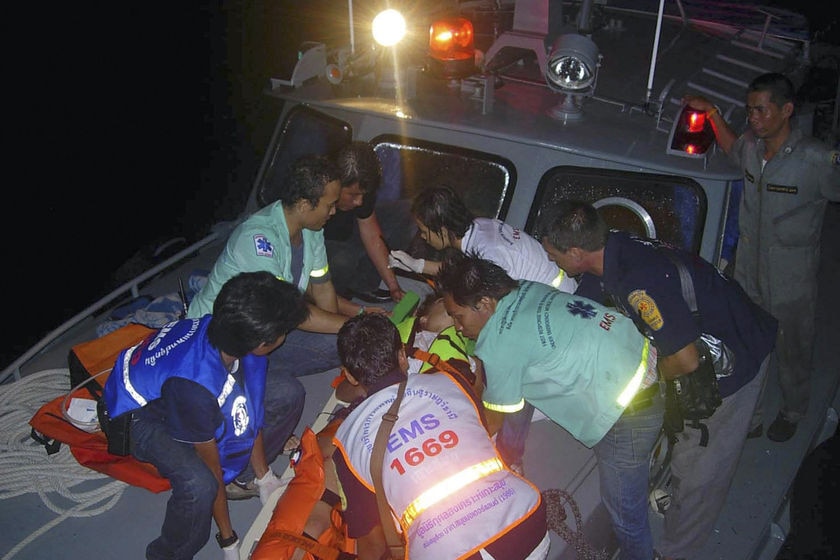 Rescue workers carry an injured victim to a hospital