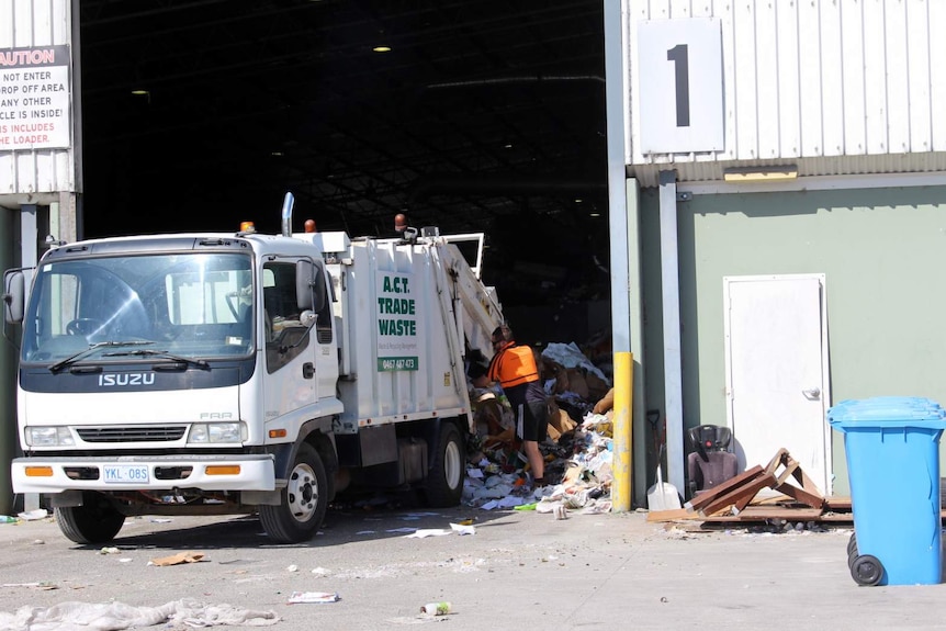 A recycling truck dumps its load at the Materials Recovery Facility at Hume, ACT.