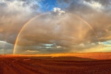 A rainbow over the Donohoe Highway, outside of Boulia, near the border in western Queensland.