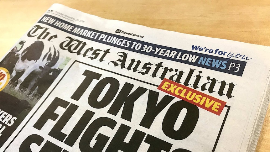 A photograph of the West Australian newspaper with a front page article on Tokyo flights and a giant cow.