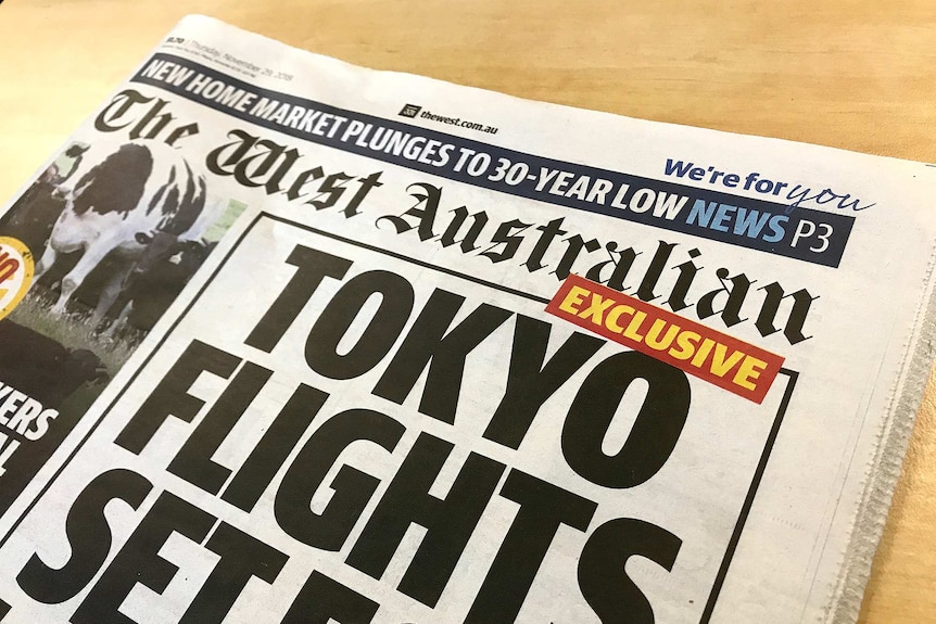 A photograph of the West Australian newspaper with a front page article on Tokyo flights and a giant cow.