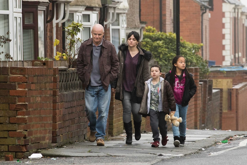 Scene of family and Daniel walking on the street, 2016