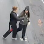 An image from CCTV footage of a woman stabbing another woman.