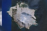 A satellite image of a volcano island from above.