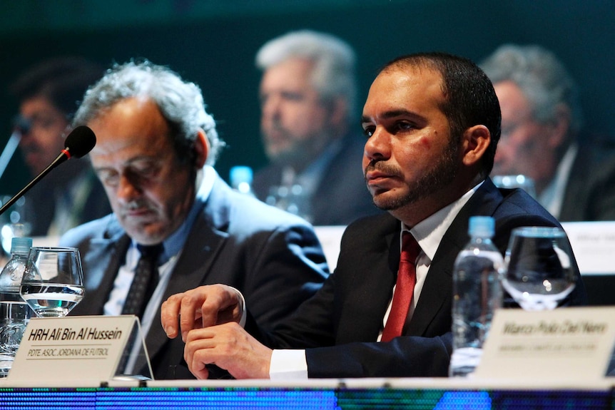 Prince Ali bin al Hussein sits alongside Michel Platini