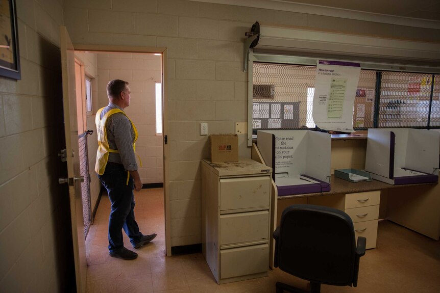 AEC officer Jason Barrow stands inside a polling place in Wanarn, WA.
