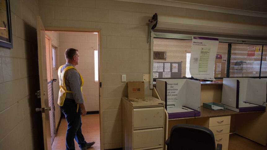 AEC officer Jason Barrow stands inside a polling place in Wanarn, WA.