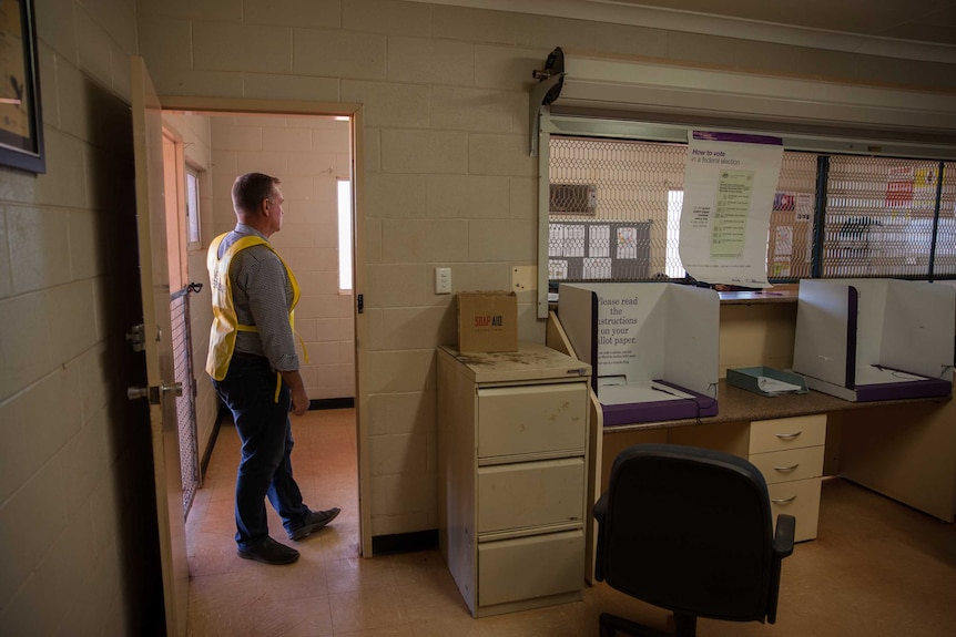 AEC officer Jason Barrow stands inside a polling place in Wanarn, WA.