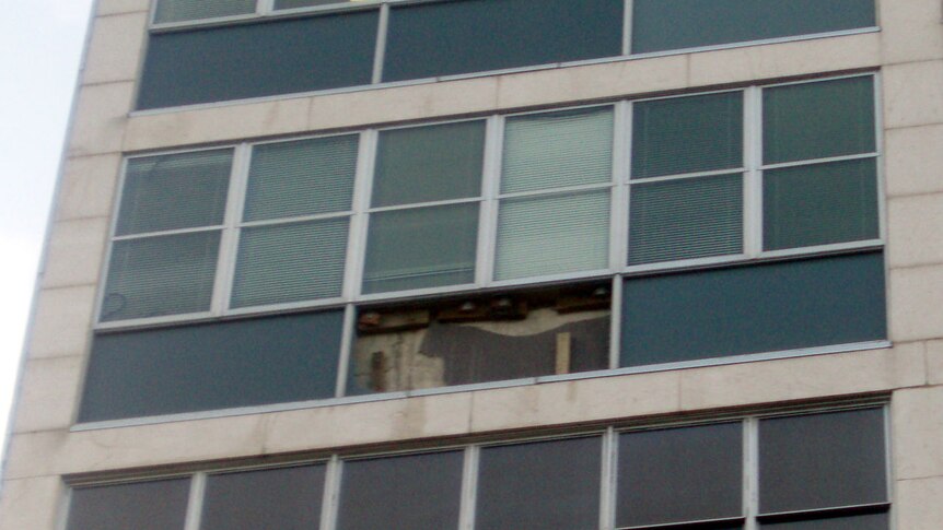 A broken window in an office block on Liverpool Street in Hobart
