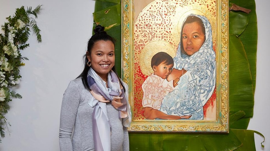 Marikit Santiago with one of her artworks from the New Sacred exhibition