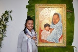 Marikit Santiago with one of her artworks from the New Sacred exhibition
