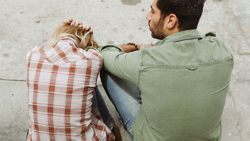 Woman and man sit with backs to camera in a story about how 2020 has affected romantic relationships.