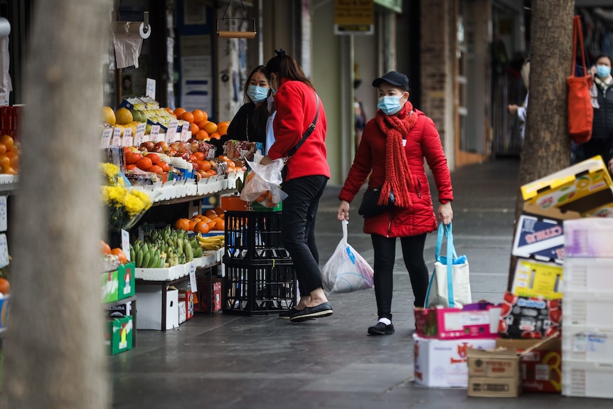 Shoppers wearing masks at a green grocer in Bankstown.
