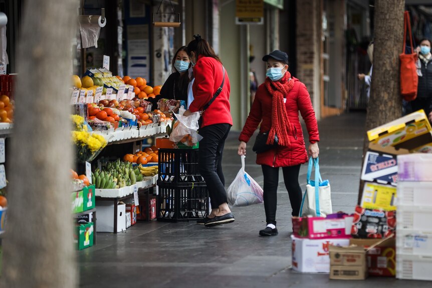 Shoppers wearing masks at a green grocer in Bankstown.