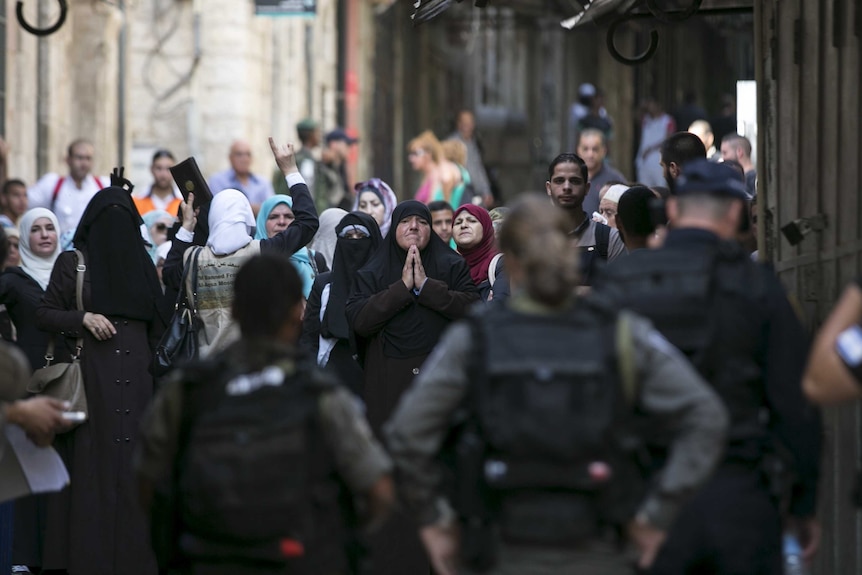 Muslim women shouts slogans as they protest in front of Israeli border police officers in Jerusalem's Old City