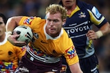 Broncos half-back Peter Wallace shrugs off a tackle