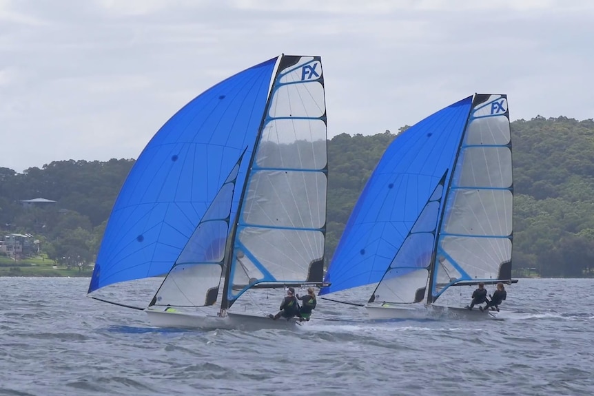 Two 49er class boats being sailed at speed on Lake Macquarie