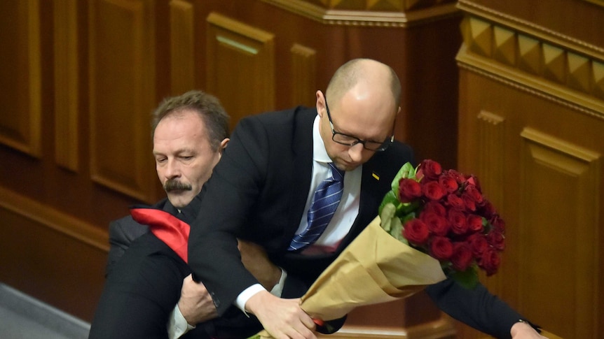 Ukraine MP Oleh Barna lifts prime minister Arseniy Yatsenuk off the ground in parliament.