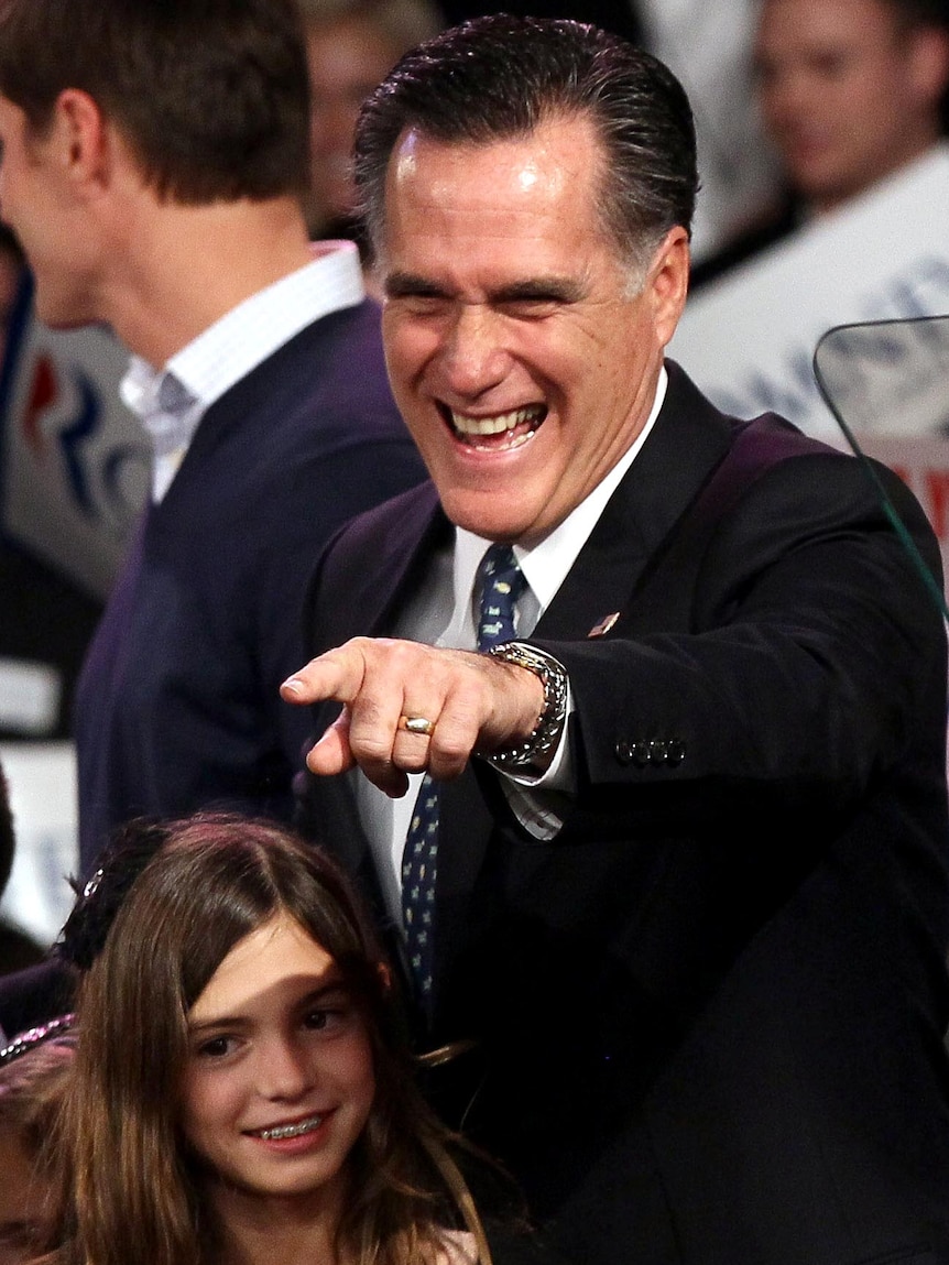 Mitt Romney points to supporters during his primary night rally in Manchester, New Hampshire.