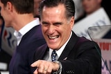 Mitt Romney points to supporters during his primary night rally in Manchester, New Hampshire.