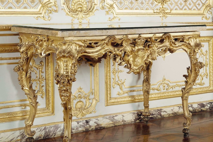 A gold and marble table.