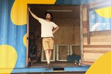 Reporter Nick Kilvert standing out the front of his backyard shed, in a story about long-term work-from-home space tips.