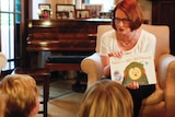 Gillard reads to children at the Lodge