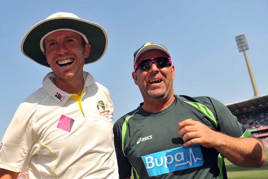 Peter Siddles and Darren Lehmann with their arms around each other celebrating Australia's Ashes triumph in 2014.