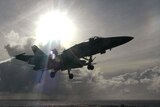 Top-gunned our outgunned?: A US Navy F/A-18E Super Hornet prepares to land on the flight deck of the USS Kitty Hawk