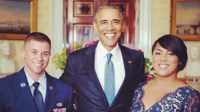 Barack Obama with a man in an air force uniform and a woman in a blue dress