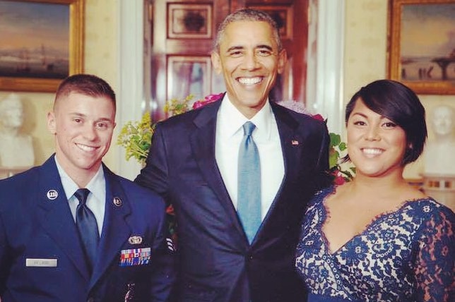 Barack Obama with a man in an air force uniform and a woman in a blue dress