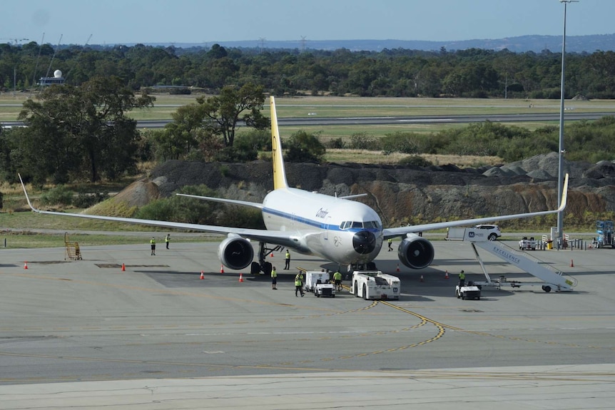 An international jet waits on the tarmac at Perth Airport