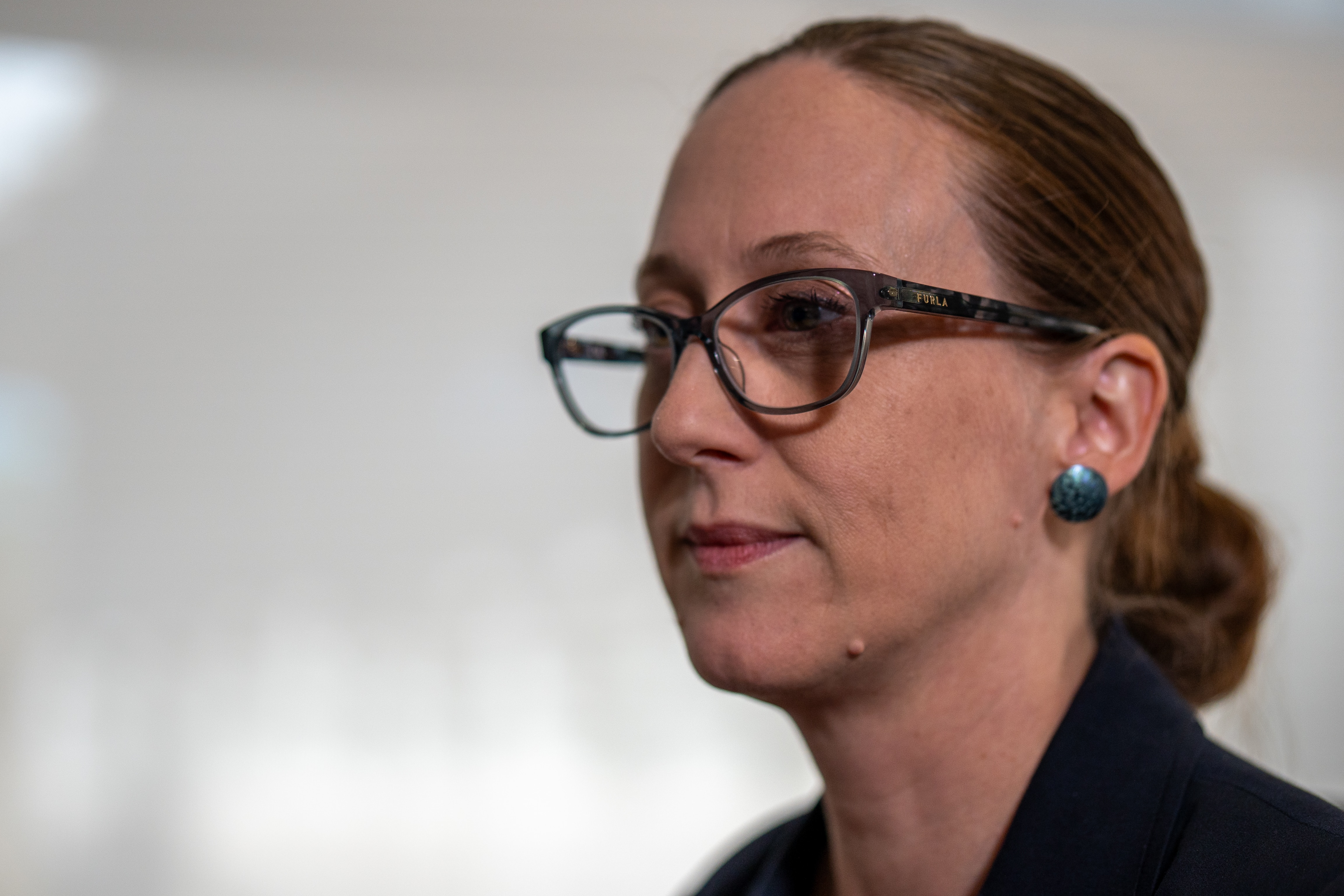 A close up with a brunette woman wearing glasses