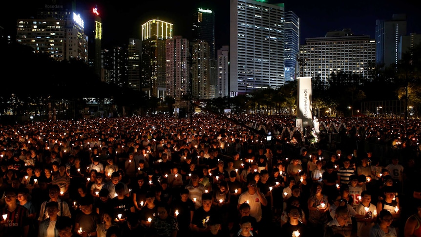 Thousands of people take park in a candlelight vigil in Hong Kong.