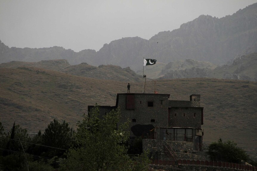 Pakistani soldiers stand guard in a hilly region on the Afghanistan-Pakistan border.