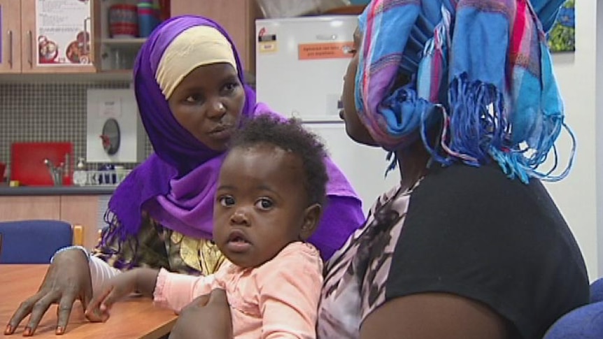 Somali refugee Hawa Hassan talks to another mother with a child