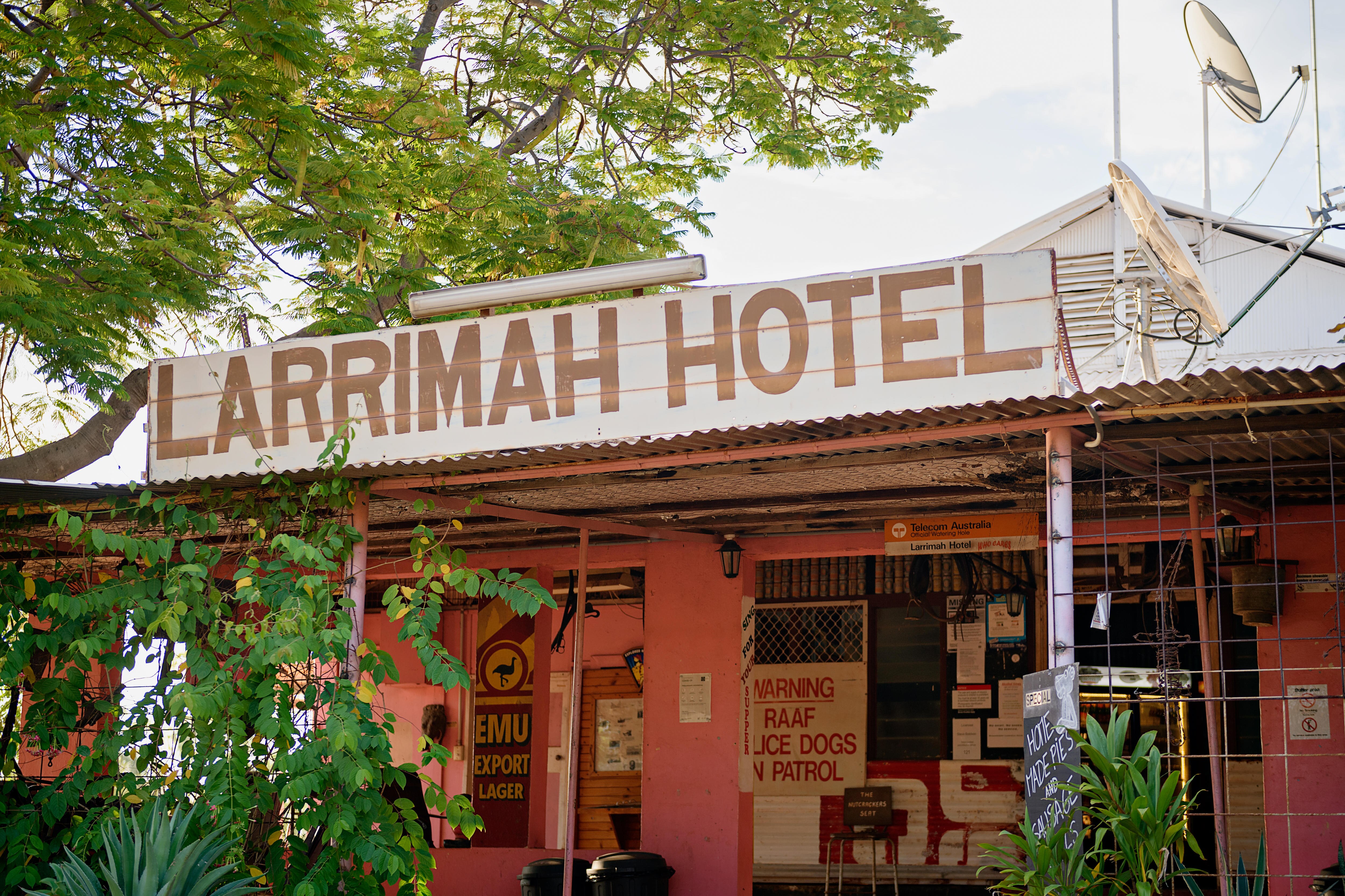 a pink pub with a sign saying &#x27;larrimah hotel&#x27;
