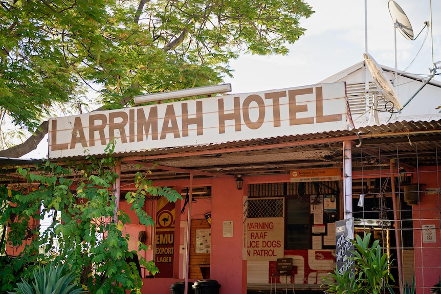 a pink pub with a sign saying 'larrimah hotel'