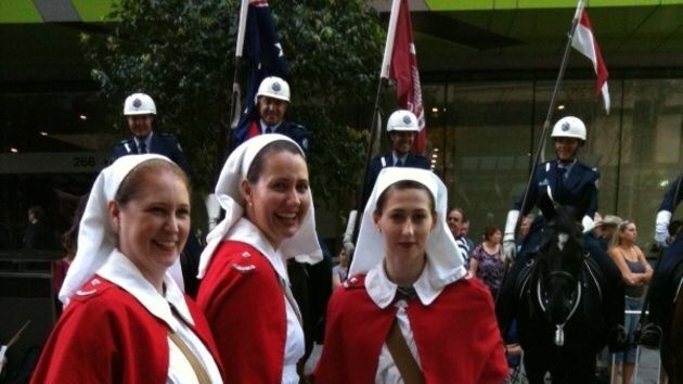 Trio dressed as war nurses at Brisbane's Anzac Day parade in the city's CBD.