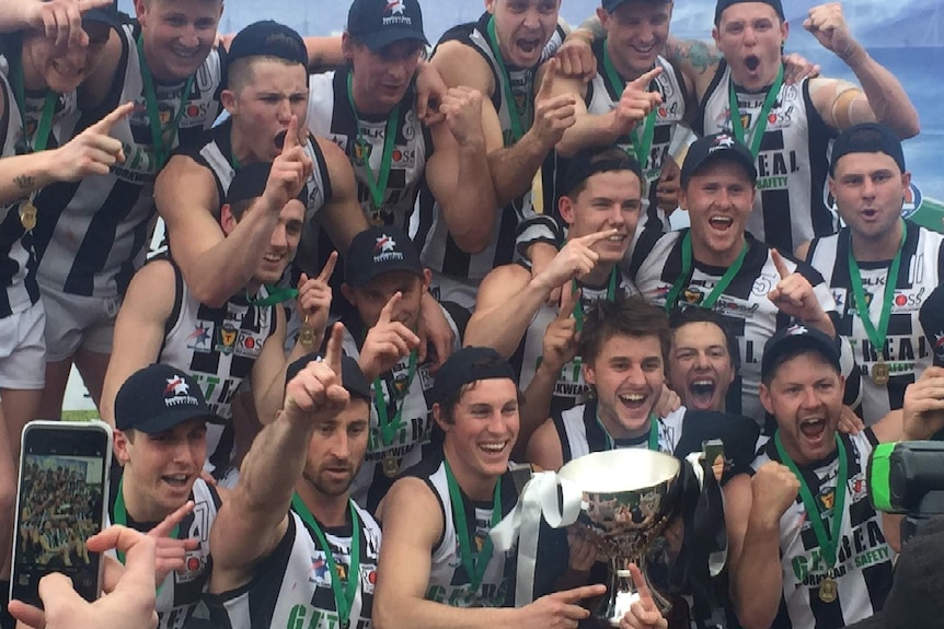 Players pose with the cup