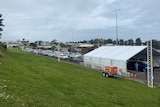 A line-up of cars at a pop-up COVID-19 testing facility.